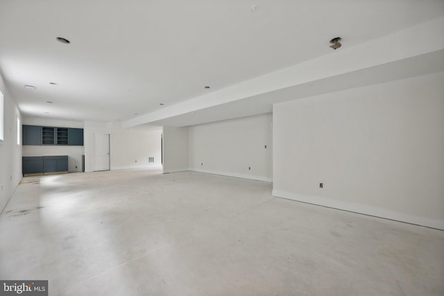 unfurnished living room with concrete flooring