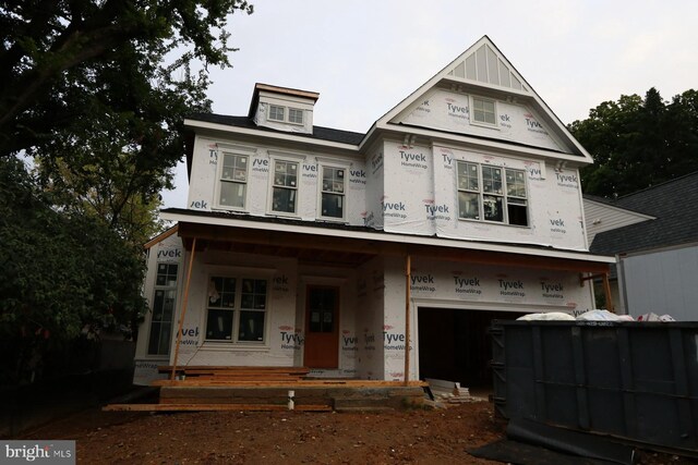 property under construction featuring a garage and a porch