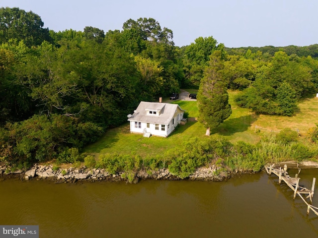 birds eye view of property with a water view and a view of trees