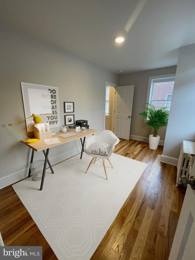 home office with recessed lighting, wood finished floors, and baseboards