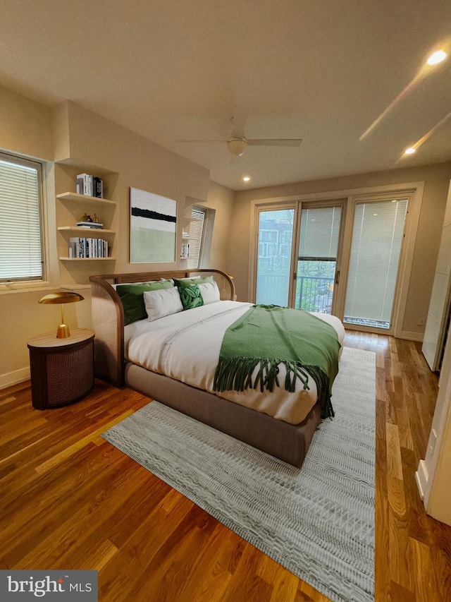 bedroom featuring baseboards, wood finished floors, a ceiling fan, and access to outside