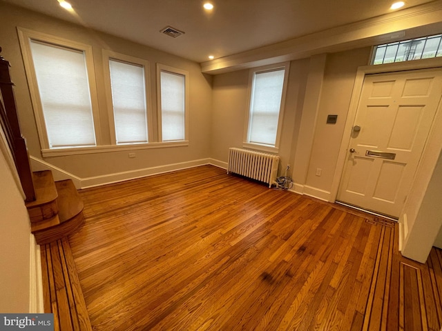 entryway featuring visible vents, radiator, baseboards, recessed lighting, and wood finished floors