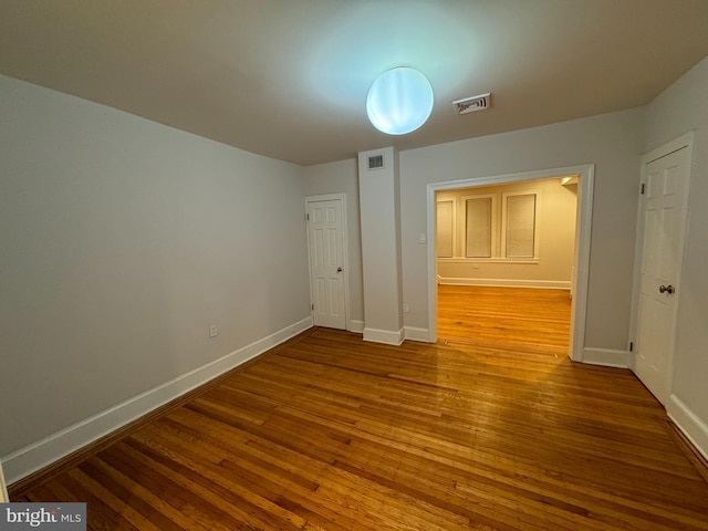 interior space with visible vents, baseboards, and wood finished floors