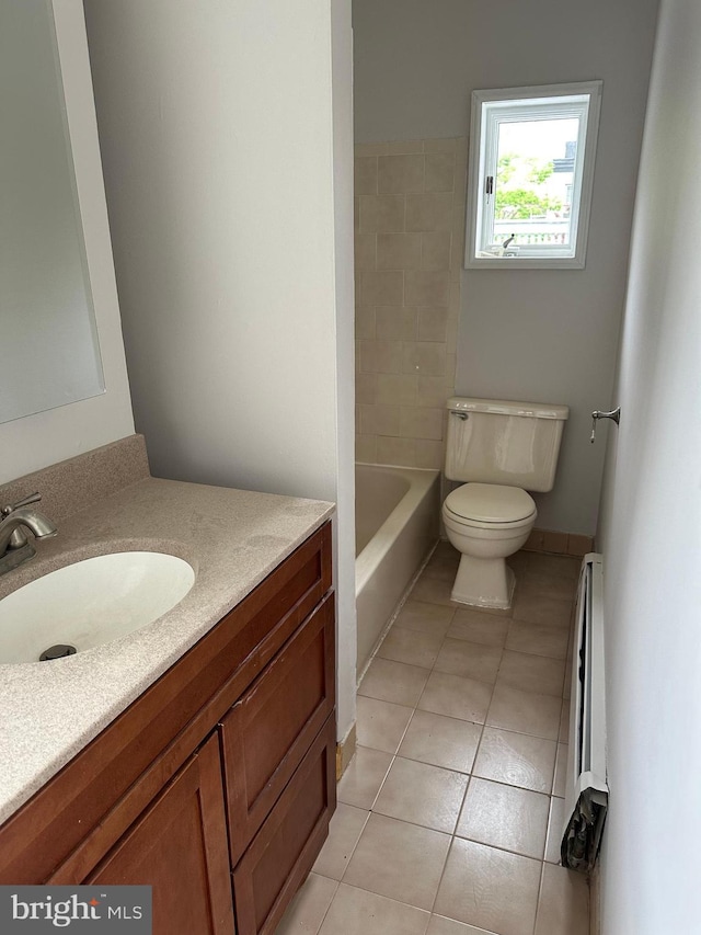 full bath featuring toilet, baseboard heating, tile patterned flooring, a bathtub, and vanity