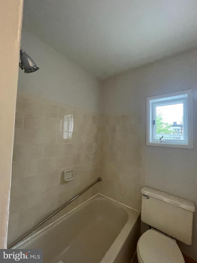 bathroom with toilet, a shower, and a tub to relax in