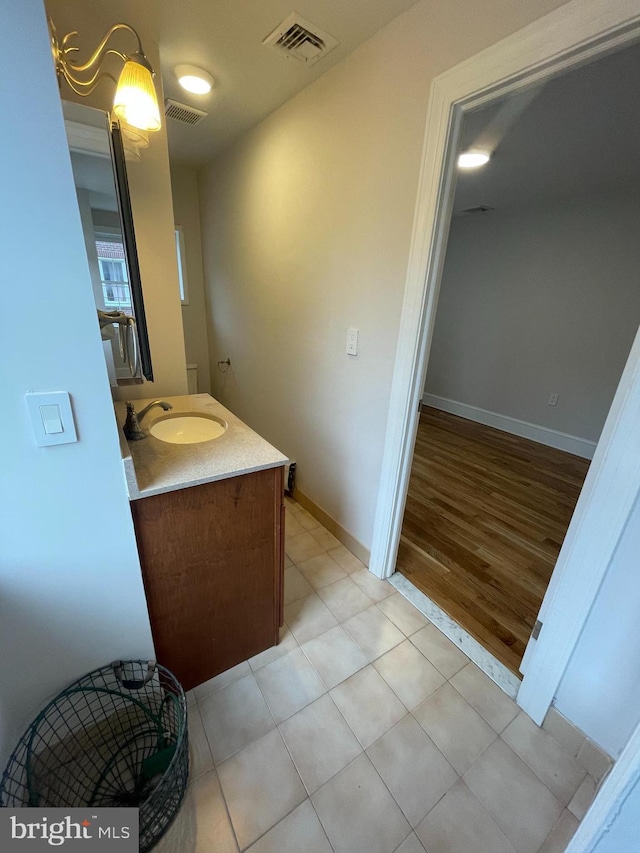 bathroom featuring vanity, tile patterned floors, baseboards, and visible vents