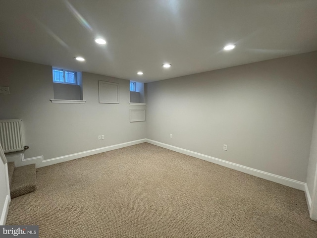 basement with stairs, recessed lighting, carpet, and baseboards