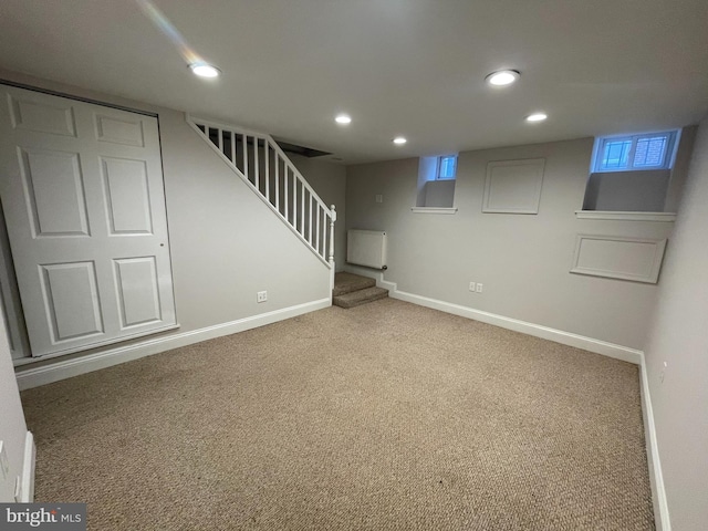 finished below grade area with stairway, recessed lighting, carpet, and baseboards