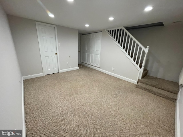 finished basement with stairs, carpet flooring, recessed lighting, and baseboards