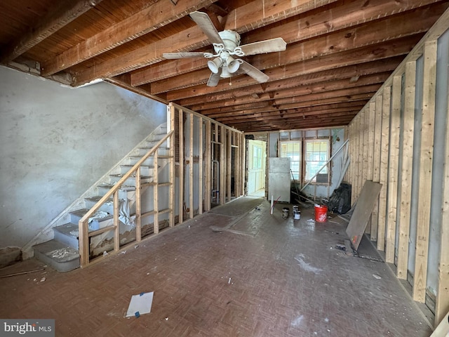 basement featuring white refrigerator and ceiling fan