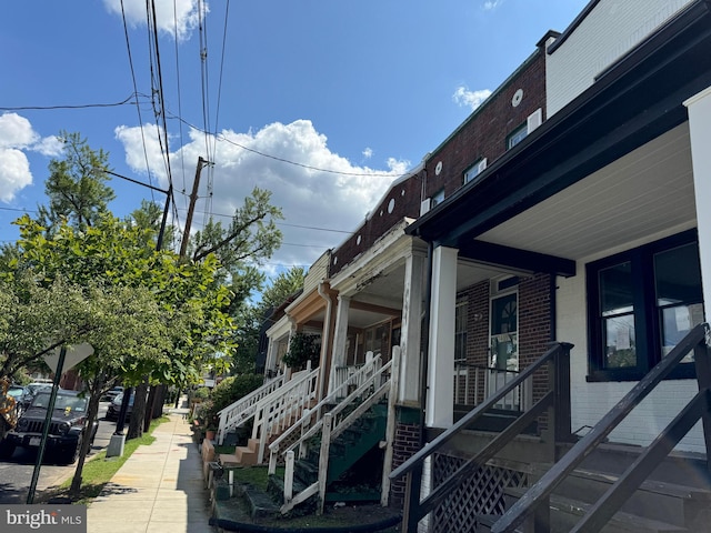 view of side of property with a porch