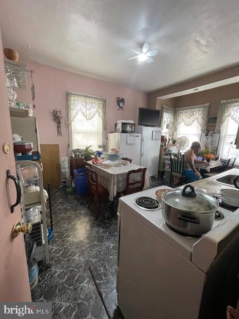 kitchen with tile patterned flooring, ceiling fan, sink, and white electric range