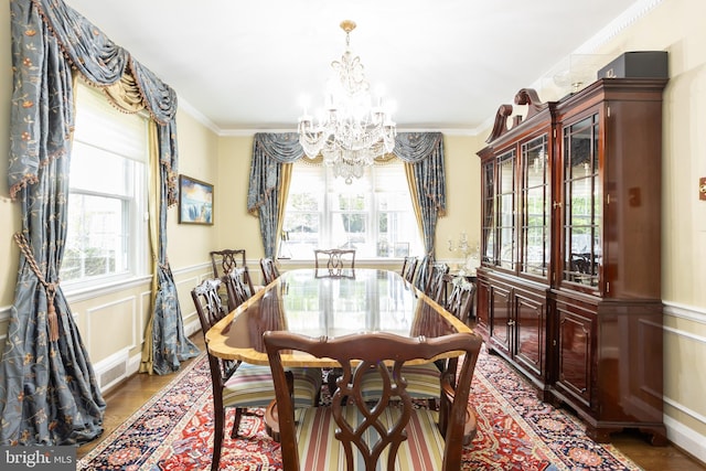 dining area with crown molding, a chandelier, and wood-type flooring