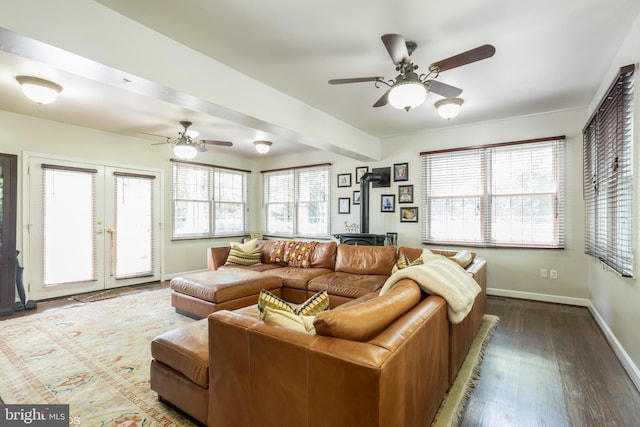 living room with french doors, a wood stove, wood-type flooring, and ceiling fan