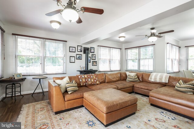 living room featuring a healthy amount of sunlight, ceiling fan, and wood-type flooring