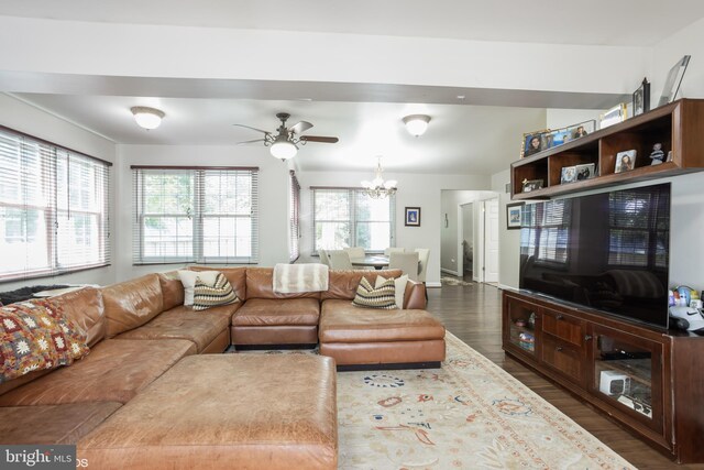 living room featuring ceiling fan with notable chandelier, dark hardwood / wood-style flooring, and a healthy amount of sunlight