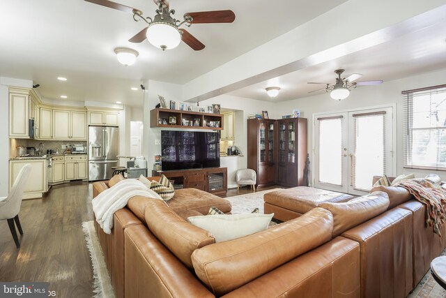 living room with wood-type flooring and ceiling fan