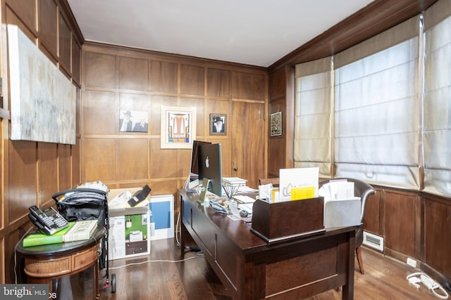 office area with wood walls and wood-type flooring