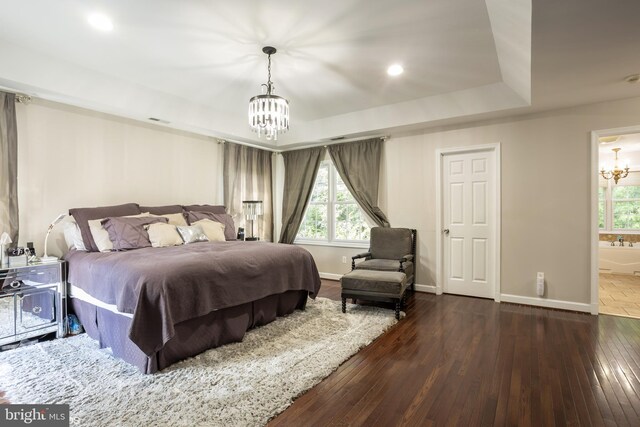 bedroom featuring dark hardwood / wood-style floors, a chandelier, and access to outside