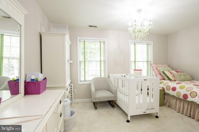 bedroom with baseboards, visible vents, a notable chandelier, and light colored carpet