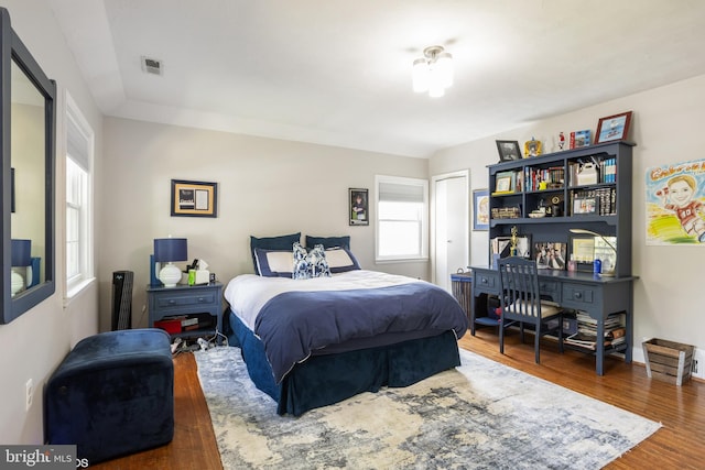 bedroom featuring visible vents and dark wood finished floors