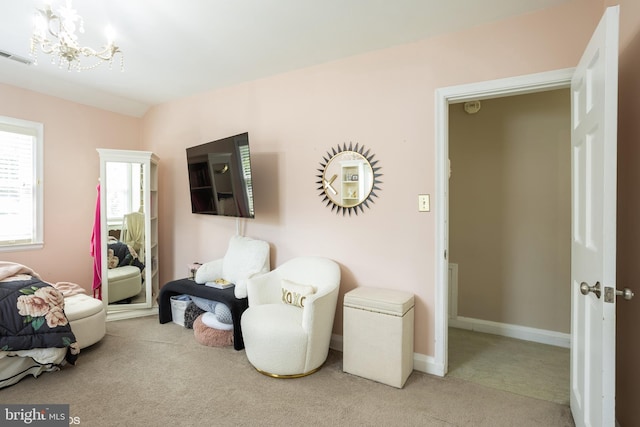 sitting room with light carpet, visible vents, and baseboards