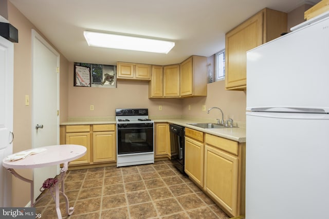 kitchen with dishwasher, freestanding refrigerator, gas range oven, light countertops, and a sink