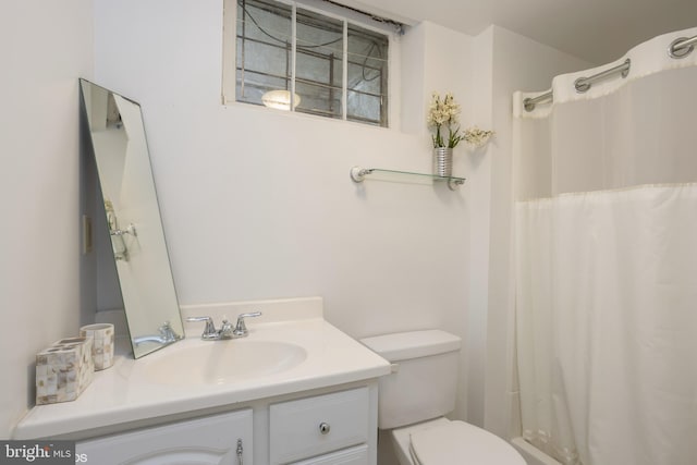 bathroom featuring vanity, toilet, and a shower with curtain