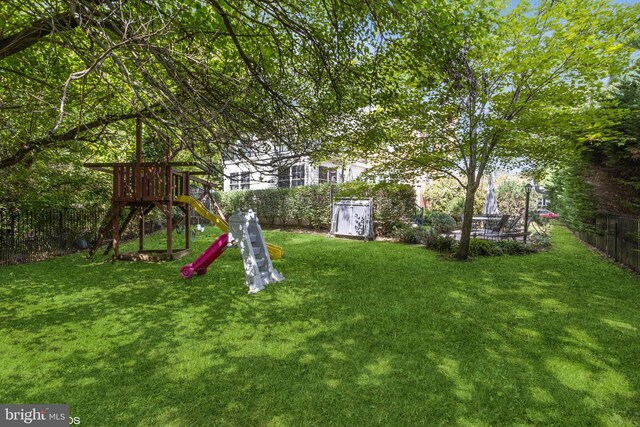 view of playground with a lawn