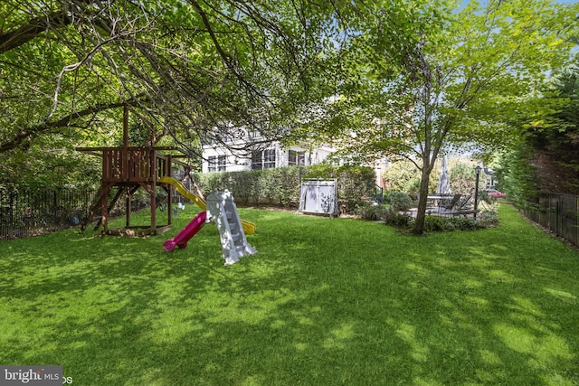 view of yard with a playground and a fenced backyard