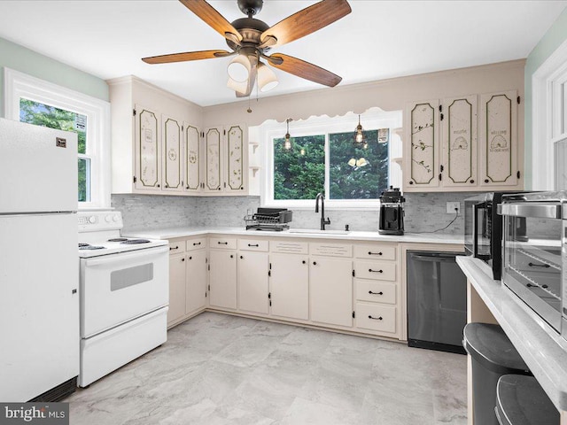 kitchen featuring white appliances, sink, cream cabinetry, decorative backsplash, and ceiling fan