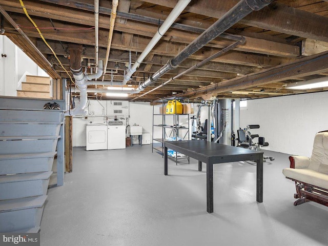 basement featuring sink and washer and dryer