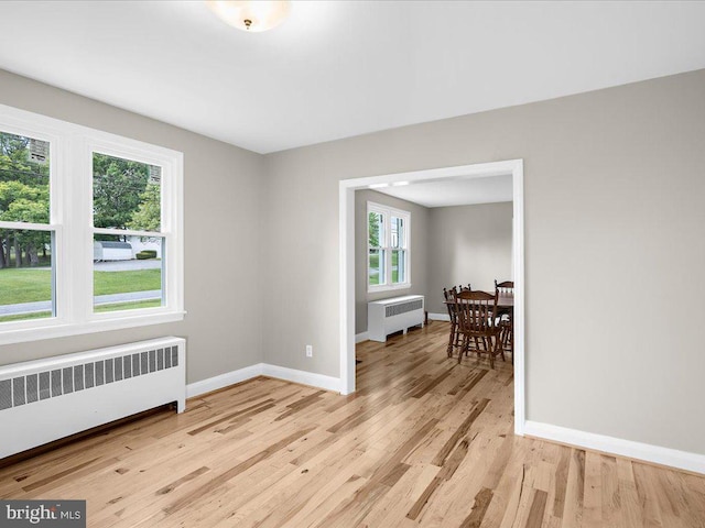 empty room featuring light hardwood / wood-style flooring and radiator