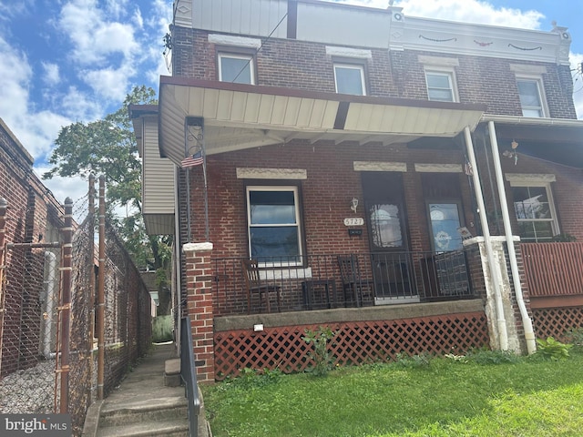 rear view of property featuring a porch