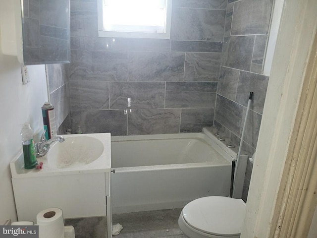 bathroom featuring toilet, a bathtub, and vanity