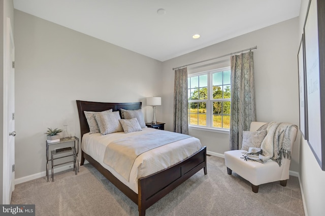 bedroom featuring light carpet and baseboards