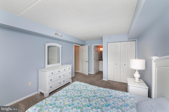 carpeted bedroom featuring a closet and a textured ceiling