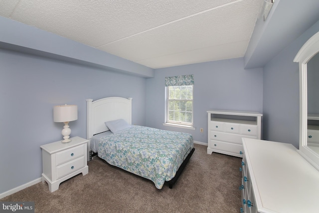 bedroom featuring carpet and a textured ceiling