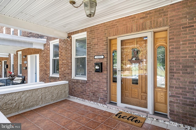 view of exterior entry with a porch