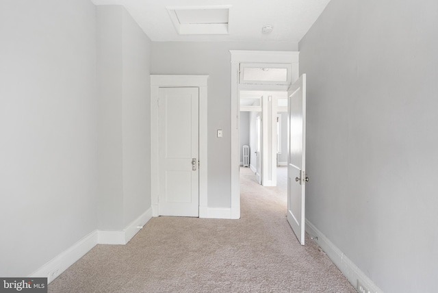 carpeted spare room featuring radiator