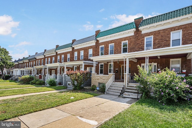 view of front of house with a porch and a front lawn