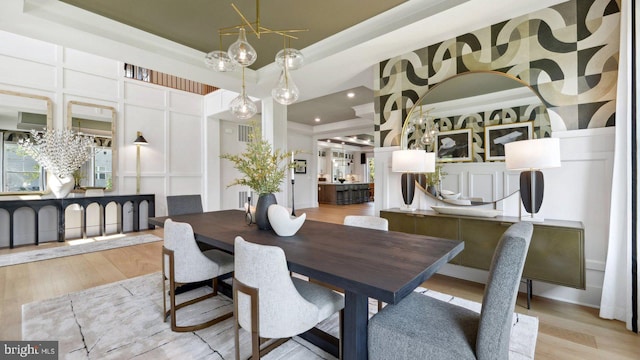 dining area featuring light wood-type flooring and a chandelier