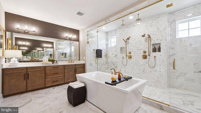 bathroom featuring shower with separate bathtub and vanity