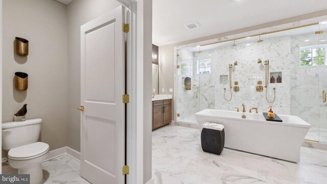 full bathroom featuring separate shower and tub, toilet, and vanity