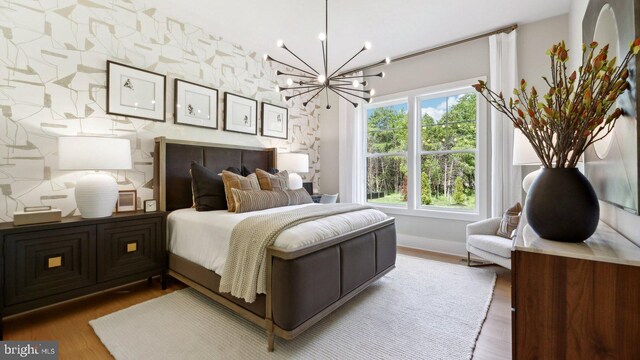 bedroom featuring a notable chandelier and hardwood / wood-style floors