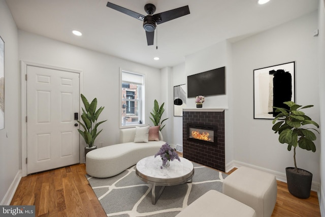 living room with hardwood / wood-style flooring and ceiling fan