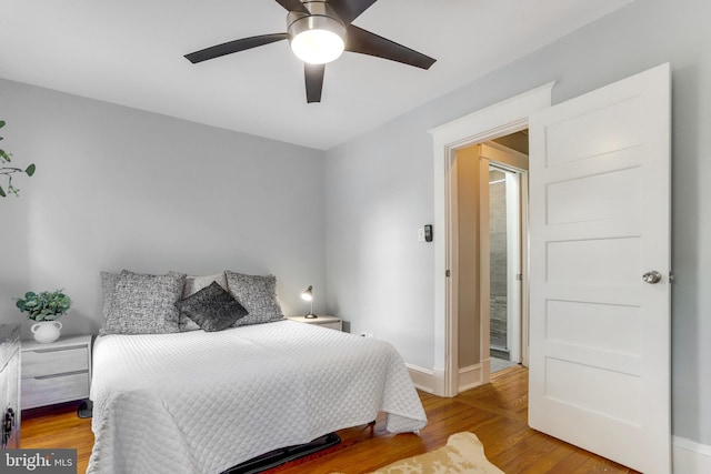 bedroom with ceiling fan and hardwood / wood-style flooring