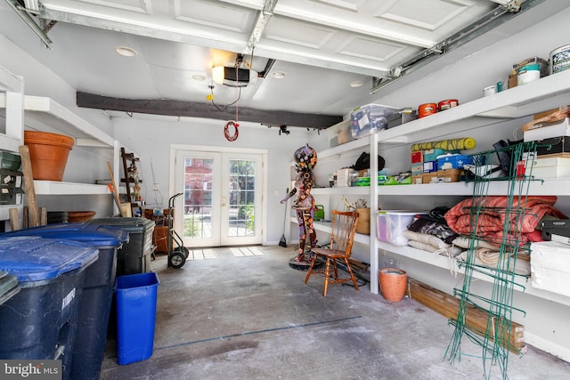 garage featuring a garage door opener, french doors, and baseboards