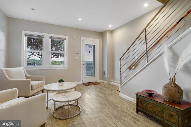 entrance foyer featuring light wood-type flooring, stairway, baseboards, and recessed lighting