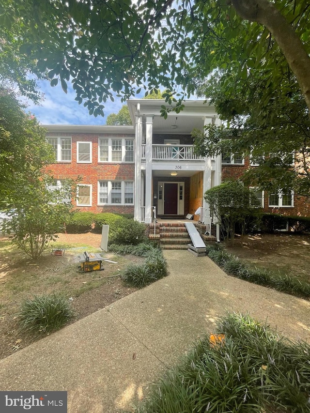 back of property with a balcony